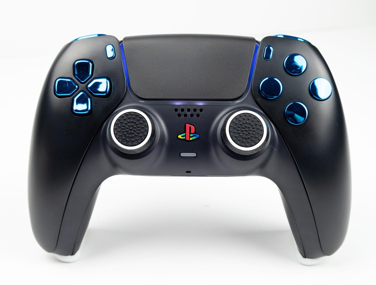 A black DualSense controller fitted with chrome blue face buttons and D-pad