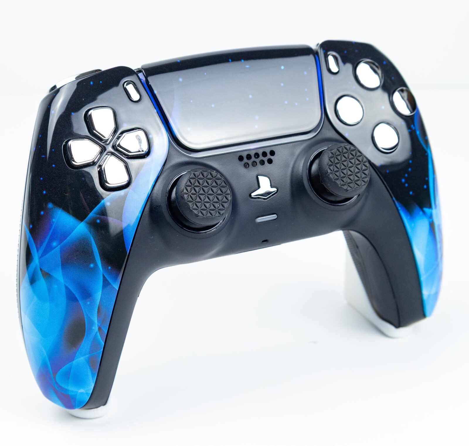 A custom blue flame DualSense controller with white replacement thumbsticks and buttons