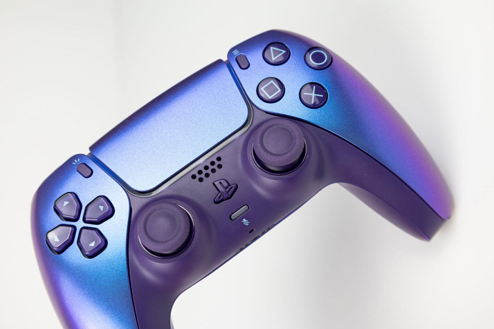 A PS5 DualSense controller in Chroma Indigo, angled to show both analogue sticks