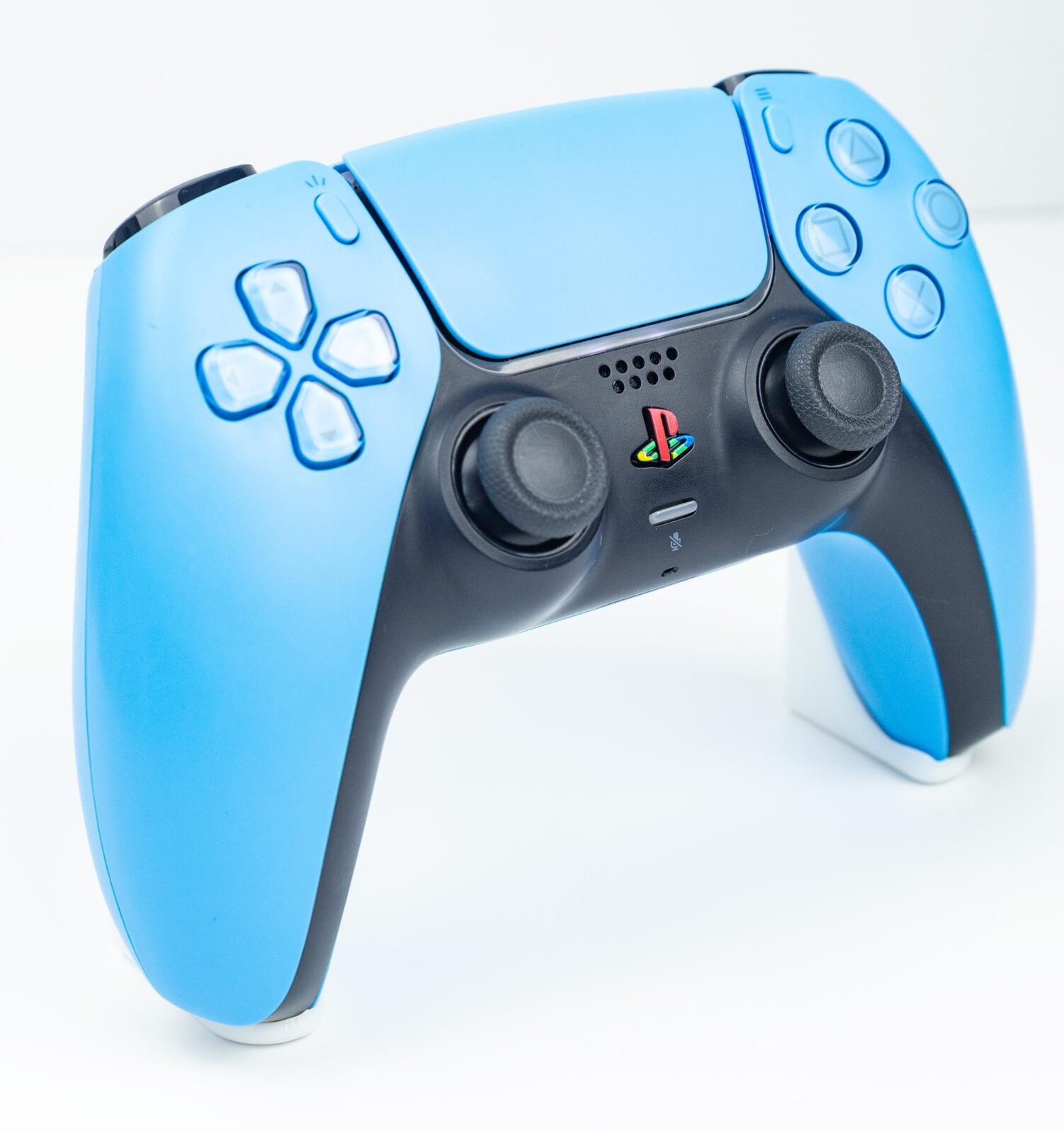 A standard white PS5 DualSense controller at an angle