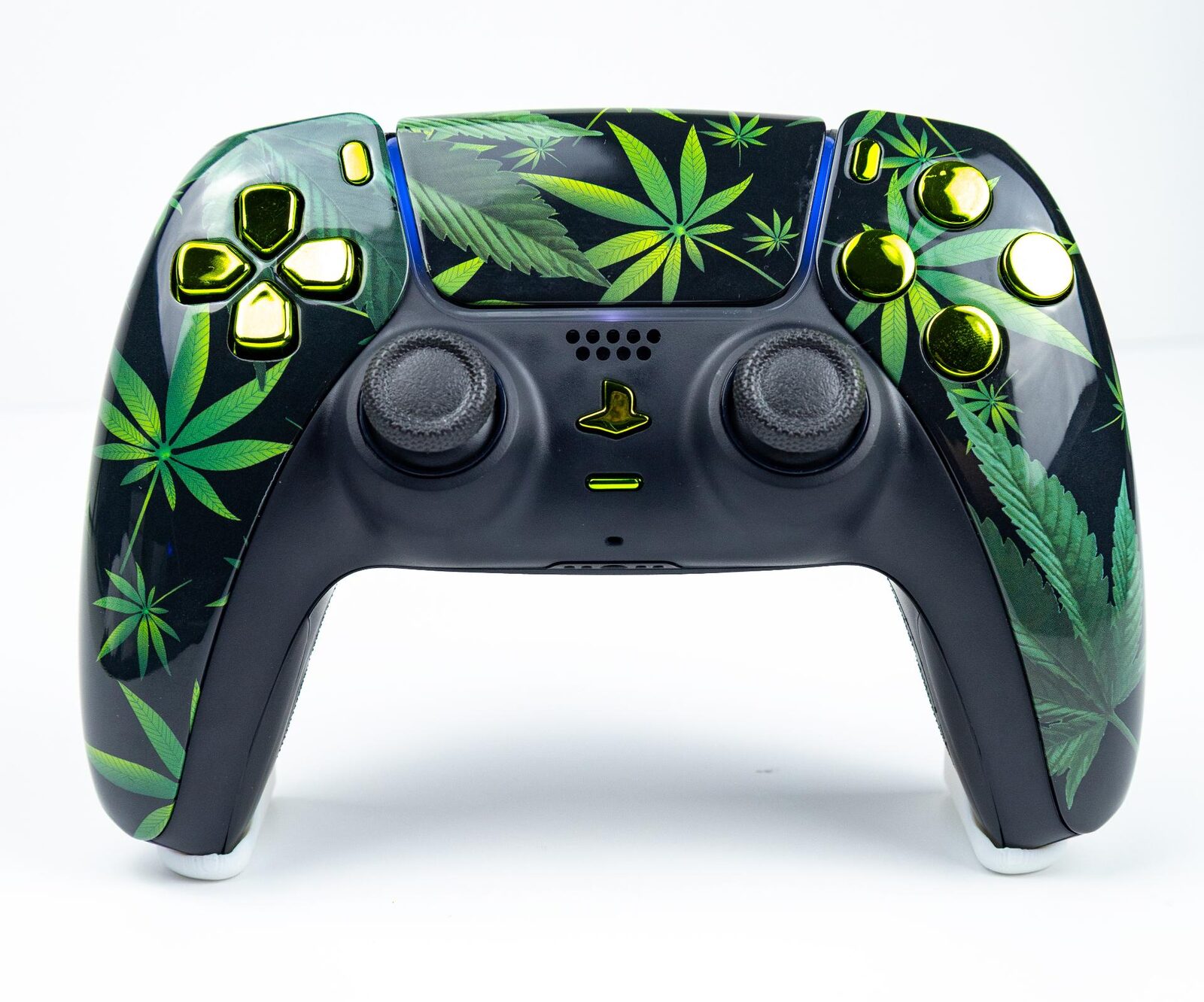 A DualSense controller with a custom printed shell in a green leaf design