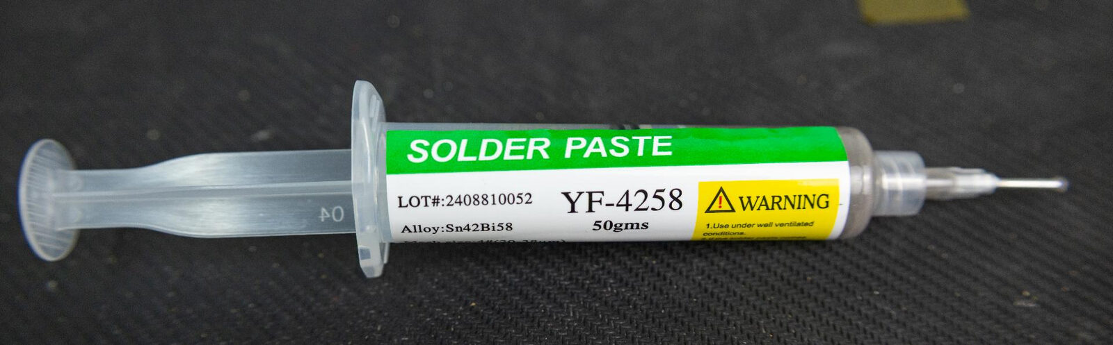A syringe of YF-4258 low-melt solder paste, labelled alloy Sn42Bi58