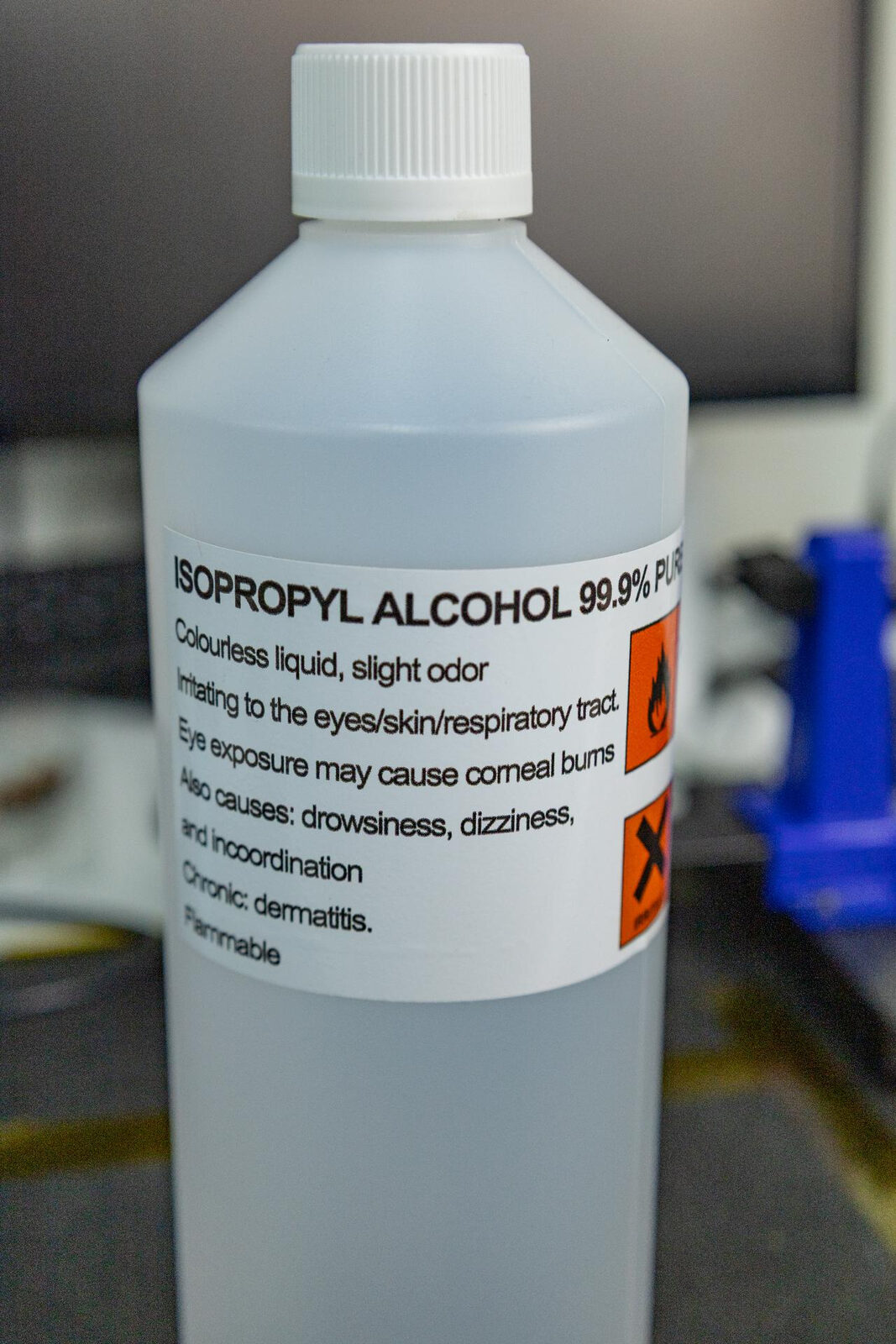 A one litre bottle of 99.9% pure isopropyl alcohol on a workbench