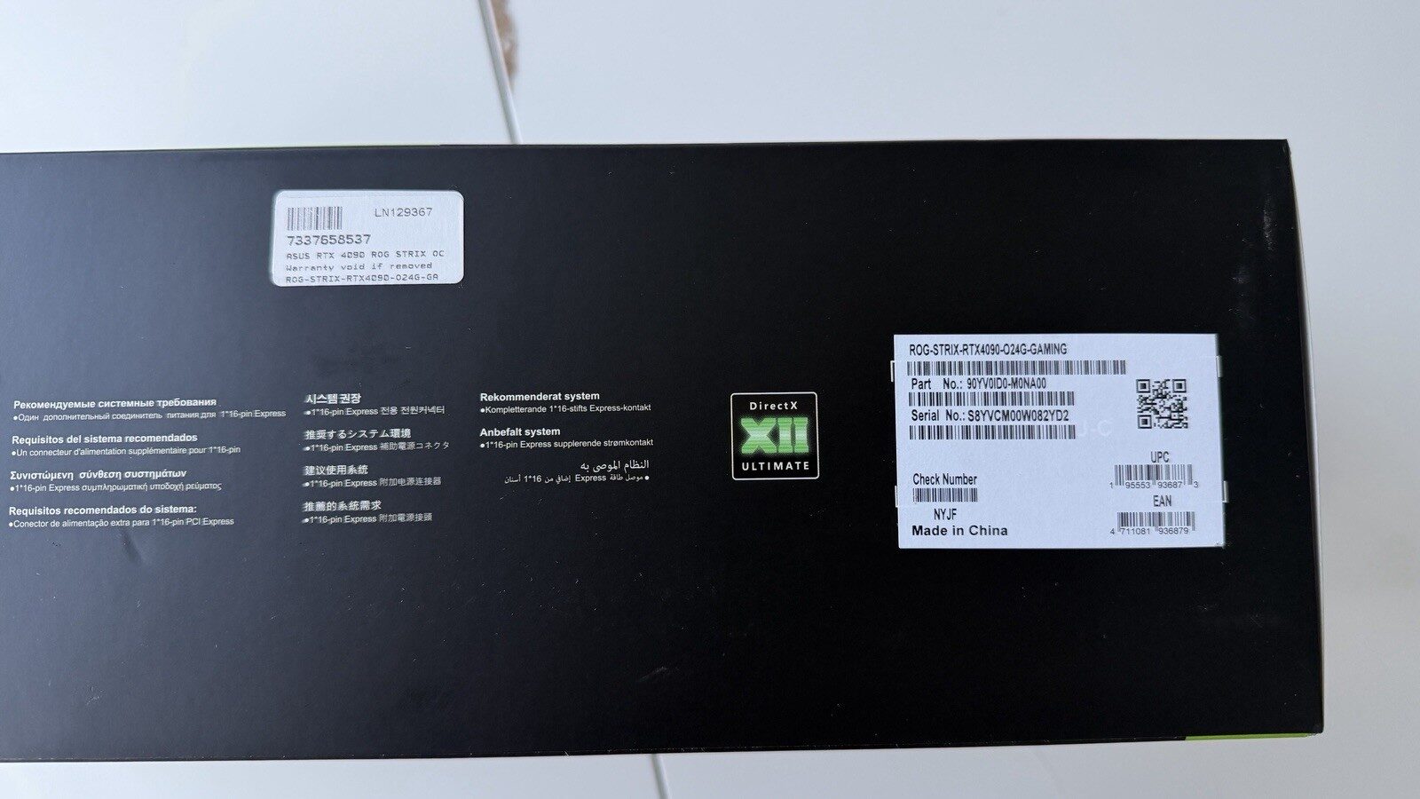 The underside of an RTX 4090 retail box showing serial number and product labels