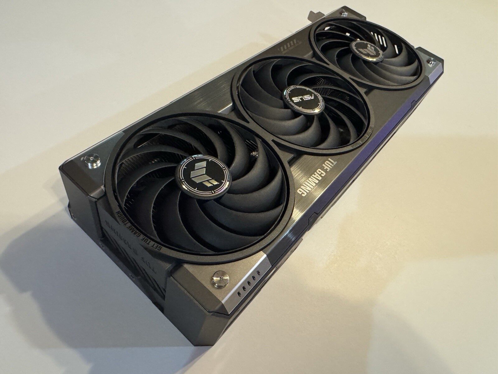 An ASUS TUF Gaming RTX 5070 Ti graphics card photographed at an angle